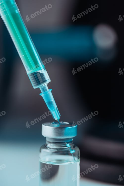 Preview: Vertical shot of pharmaceutical syringe with needle in a medicine and pills - illegal doping drugs