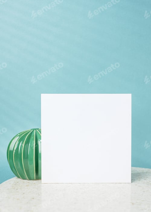 Preview: blank poster paper card with flower vase and cactus decor on stone table wtih blue background