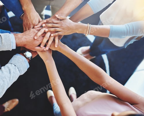 Preview: Cropped shot of a group of businesspeople standing in a huddle with their hands stacked