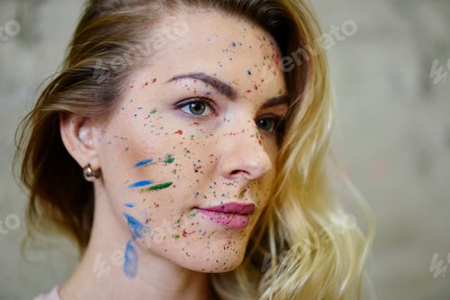 Preview: Pensive Caucasian woman with acrylic dye on body pondering on technique