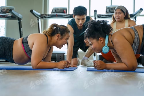 Preview: Plus size women workout at fitness center.