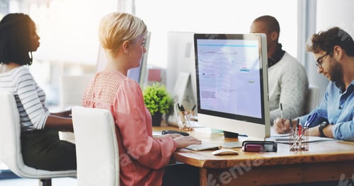 Preview: Shot of a group of businesspeople working on computers in an office
