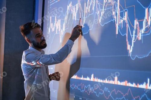 Preview: Man is standing near projector and showing graphs and business graphs