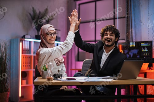 Preview: Two multi ethnic economists giving high five
