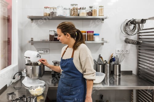 Preview: Pastry chef putting chunks of butter into a mixer