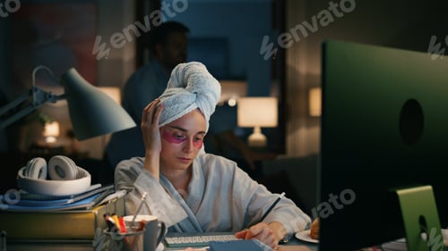 Preview: Busy worker writing notes at night flat closeup. Tired girl trying concentrate