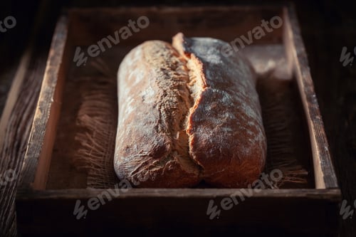 Preview: Closeup of loaf of bread on dark and rustic table