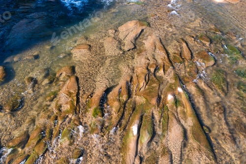 Preview: River rapids near mountain foothill with terracotta forests