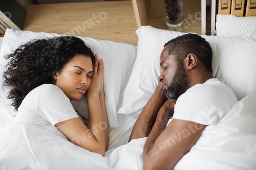 Preview: African american couple sleeping face to face in bed