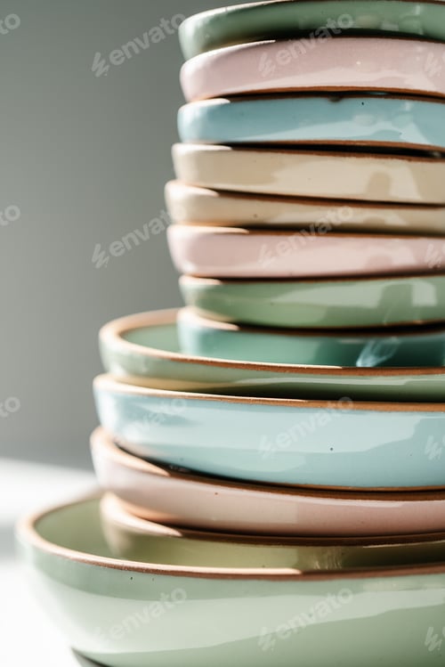Preview: A large stack of ceramic cups in pastel colors.