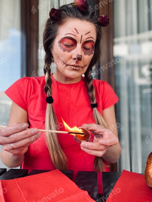 Preview: Woman in red dress and with a special face makeup for celebration dead people day