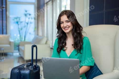 Preview: Woman traveler with notebook computer waiting check in hotel,People and technology concept.