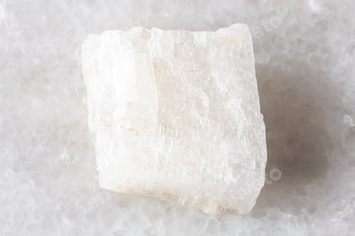 Preview: sample of raw colorless calcite rock on white