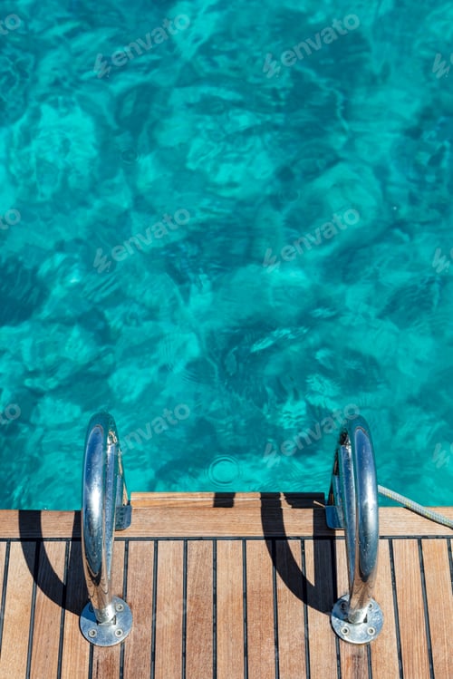 Preview: Wooden platform with metal ladder for dives in Aegean sea Kimolos island Cyclades Greece. Vertical