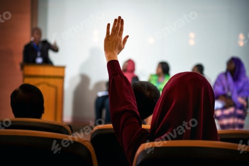 Preview: A Person Raising Her Hand to Ask a Question in a Panel Discussion