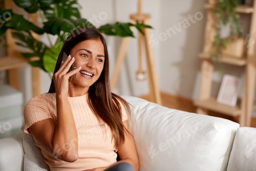 Preview: Smiling Woman Talking on Phone at Home