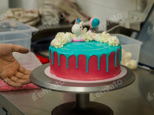 Preview: frosted pink blue cup cake with meringue, sweet sprinkles and unicorn topping