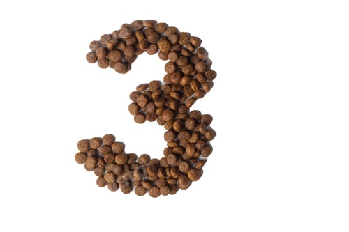 Preview: Number 3 made from dry pet food on white background. Dietary therapeutic nutrition for dogs and cats