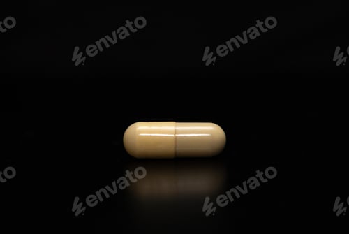 Preview: Close-up of a medicine capsule on a black background, perfect for an ornamental or decorative image