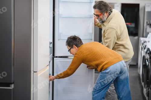 Preview: Senior couple choosing new refrigerator in appliance store