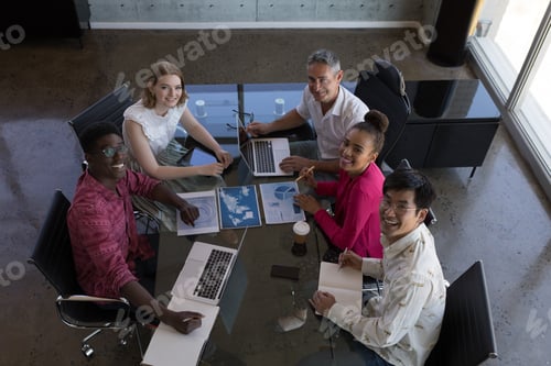Preview: Portrait of diverse business colleagues working together and looking over graphs in modern office