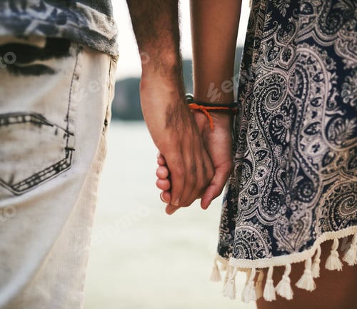Preview: Closeup shot of a young couple holding hands at the beach