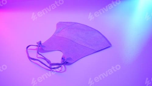 Preview: Closeup shot of a protective face mask under purple light