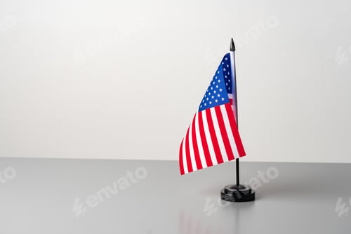 Preview: Little flag of USA on gray table close up