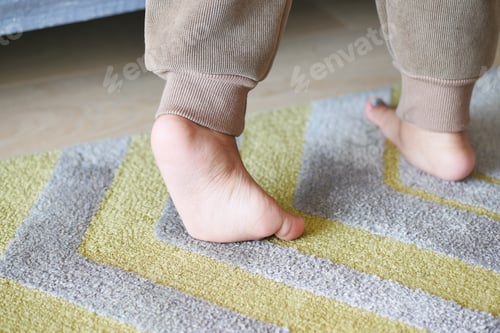 Preview: low angle view of A child walking on tiptoes
