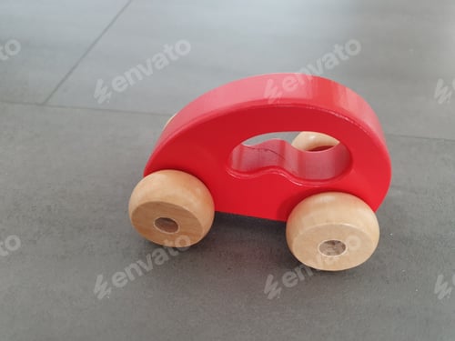 Preview: Wooden red toy car on the ground