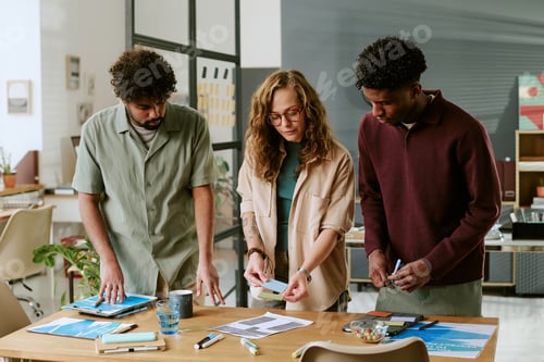 Preview: Young Multiethnic Colleagues Collaborating on Project in Modern Office Setting