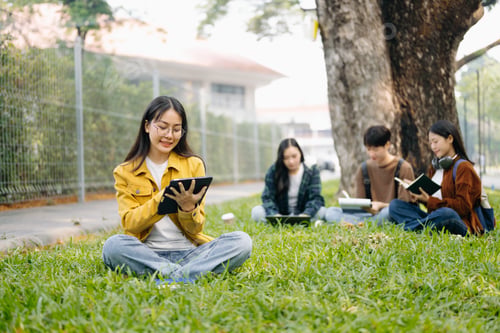 Preview: Asian Students are studying the campus park. Young people are spending time together.