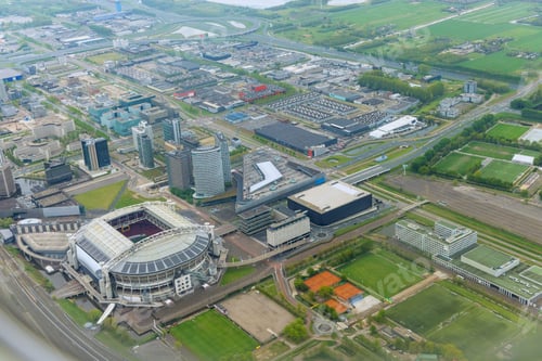 Preview: An aerial view of city Amsterdam in cloudy weather of rooftops over a neighborhood city