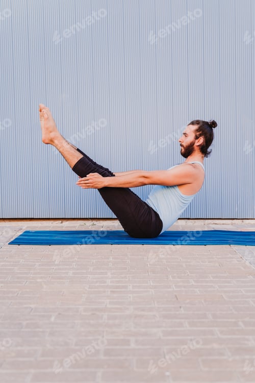 Preview: hispanic man in the city practicing yoga sport. blue background. healthy lifestyle