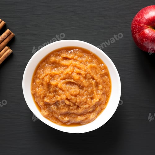 Preview: Homemade Raw Apple Sauce in a White Bowl on a black background, top view. From above.
