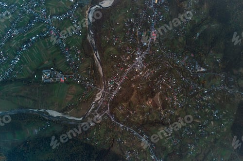 Preview: Aerial view from high altitude of distant scattered houses in rural area