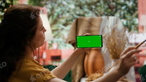 Preview: Painter holding a device with isolated mockup screen in art studio