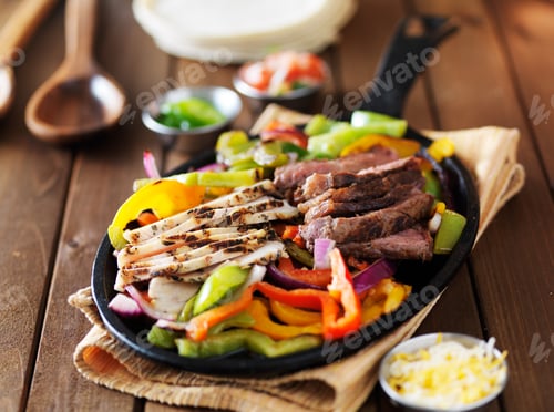 Preview: chicken and steak mexican fajitas in iron skillet