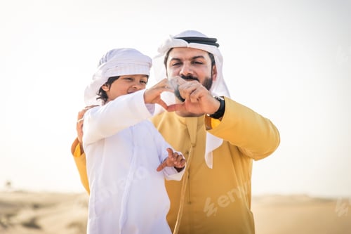 Preview: Arabian man and son playing in the desert