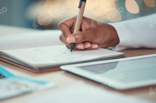 Preview: Closeup on hands of a doctor writing in a journal. Doctor planning in a notebook. African american