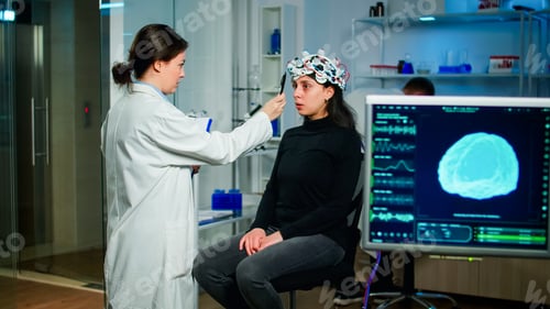 Preview: Medical researcher preparing patient for examining brain functions