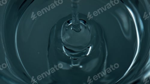 Preview: Liquid droplet falling water top view. Closeup refreshing drink waving rippling
