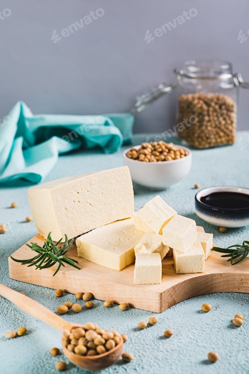 Preview: Fresh sliced soy tofu cheese and rosemary on wooden board on table vertical view