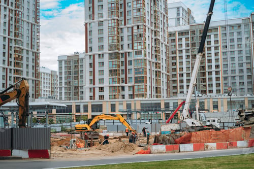 Preview: workers and technic work at modern construction site of appartment recidential building in city.