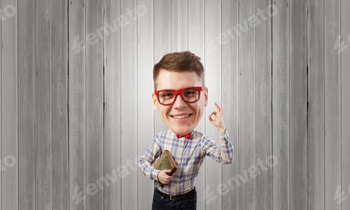 Preview: Young Funny Big Headed Man In Glasses With Book In Hands Showing Ok Gesture