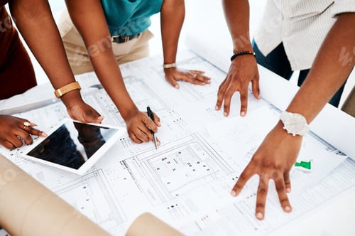 Preview: Cropped shot of a group of colleagues going over blueprints in a modern office