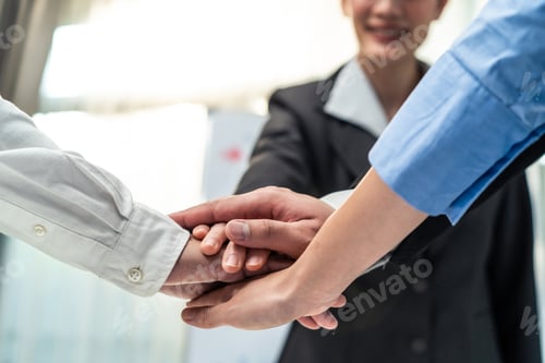 Preview: Group of business people stack hands put palms together to motivate for corporate success