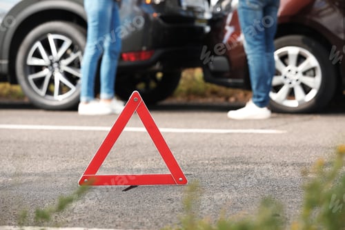 Preview: Emergency stop sign near people discussing car accident on road. Auto insurance