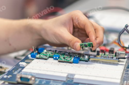 Preview: engineer hold circuit or silicon chip in his workplace b