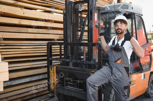 Preview: Warehouse worker gesturing thumbs up while sitting on forklift near lumber